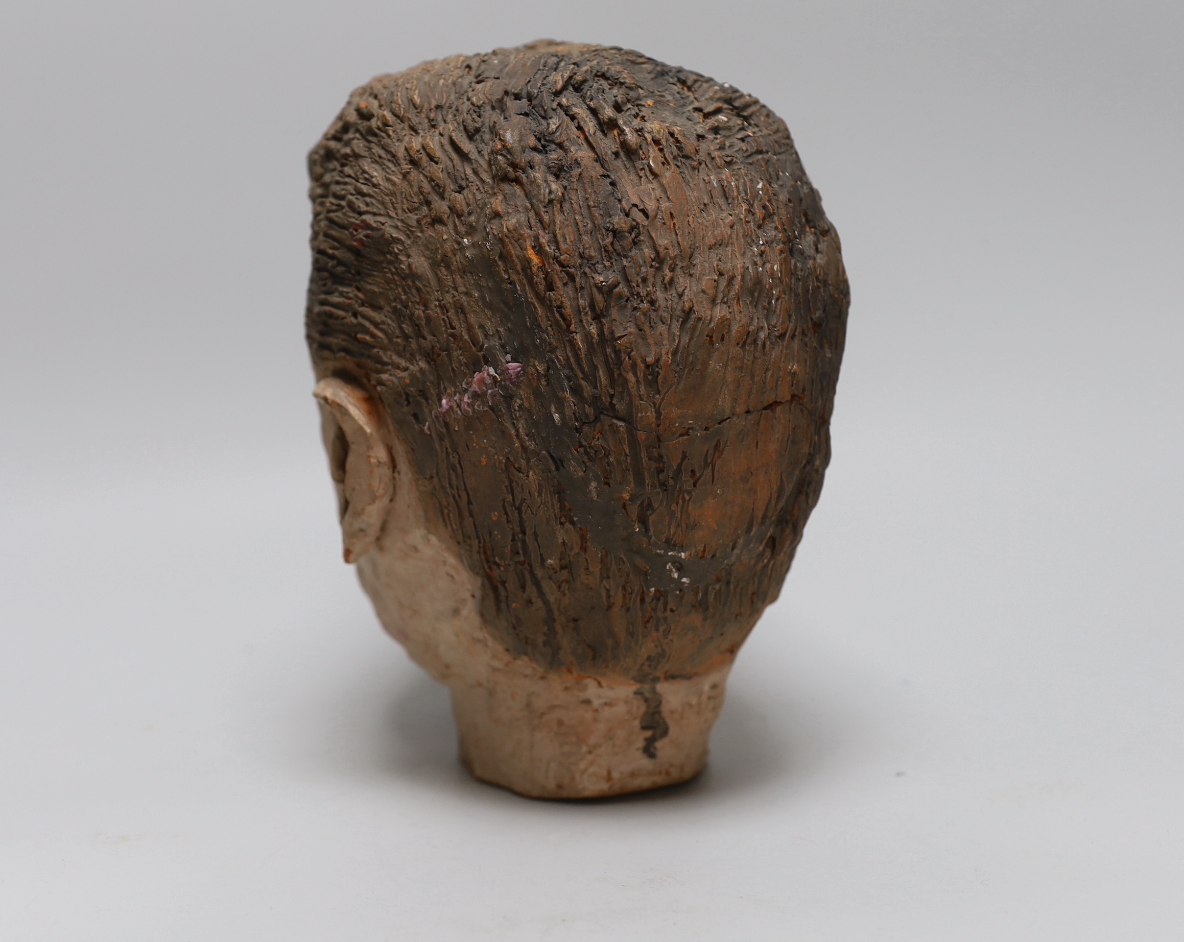 A terracotta bust of a boy, back of neck signed, 23cm